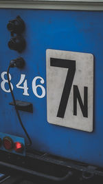 Close-up of arrow sign on road