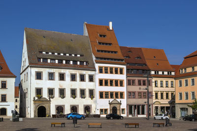 Buildings against clear blue sky in city