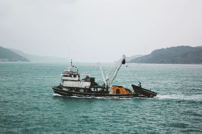 Big fishing boat and foggy bosphorus view. istanbul, turkey.