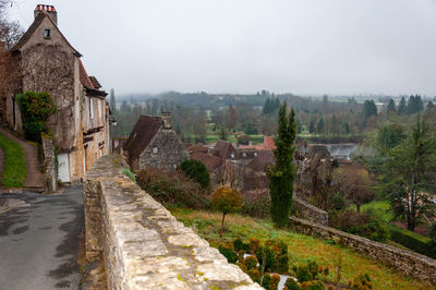 Panoramic view of trees and houses against sky