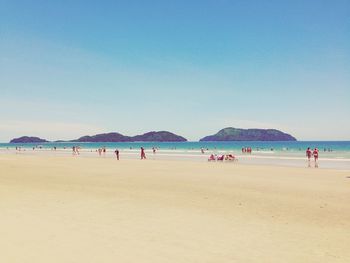 Distance shot of people on beach