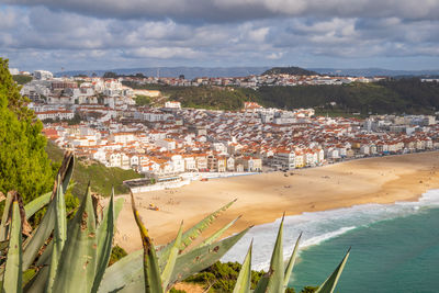 Aerial view over nazaré town, portugal, down to beach and atlantic ocean