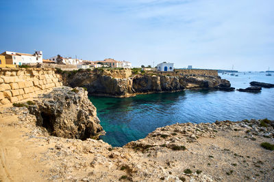 Rock formations by sea against sky at tabarca