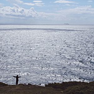 Scenic view of sea against cloudy sky