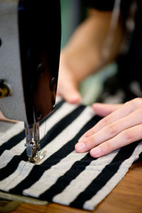 Cropped hand of woman playing piano