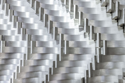 Full frame abstract industrial background of tightly laid shiny steel parts after milling operations