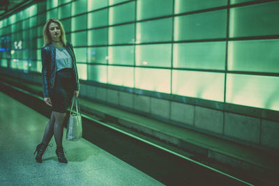 Full length of woman standing at subway station platform