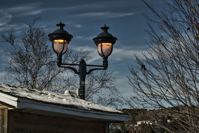 Low angle view of street light against building