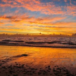 Scenic view of beach against sky during sunset