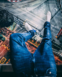 Low section of man with umbrella on street