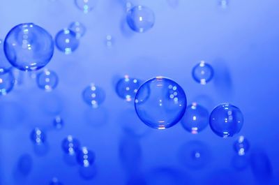 Close-up of bubbles against blue water