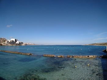 Scenic view of sea against blue sky