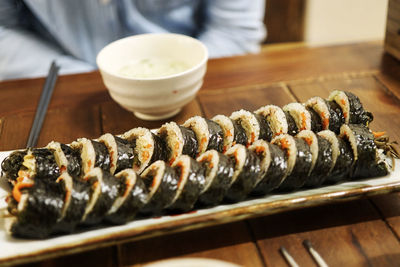 Close-up of hand holding bread on table