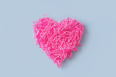 Close-up of heart shape over pink background