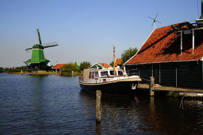 Boats in river with buildings in background