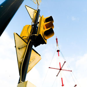 Low angle view of crane against sky