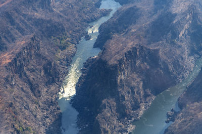 High angle view of river amidst mountains