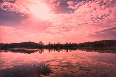 Scenic view of lake against romantic sky at sunset