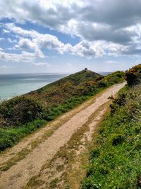 Road by sea against sky