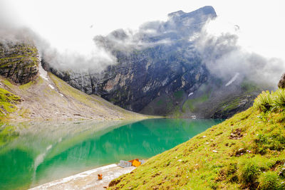 Scenic view of lake and mountains against sky