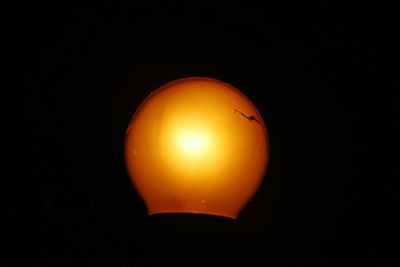 Close-up of illuminated orange black background