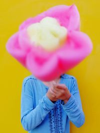 Girl holding large candy in front of face