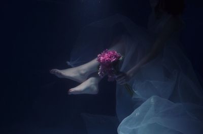 Close-up of woman hand against black background