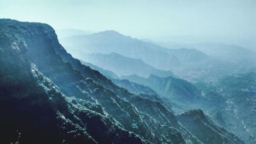 Scenic view of mountains against cloudy sky