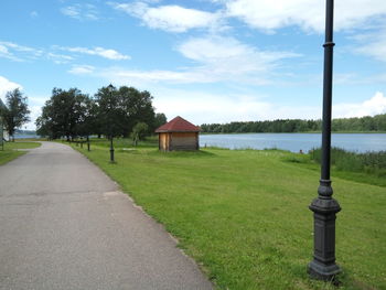 Park by water against sky