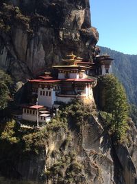 View of temple and buildings against mountain