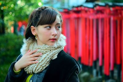 Portrait of young woman looking away outdoors