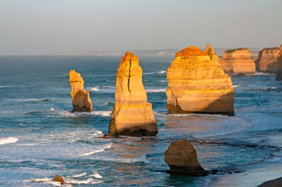 Rocks in sea against sky