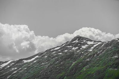 Low angle view of snowcapped mountains against sky