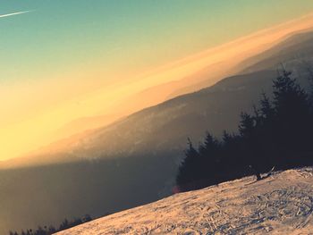 Scenic view of snowcapped mountains against sky during sunset