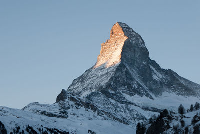 Scenic view of snowcapped mountain against clear sky