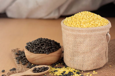 Close-up of split mung beans and black beans on table