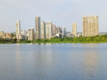 Buildings in city against clear sky