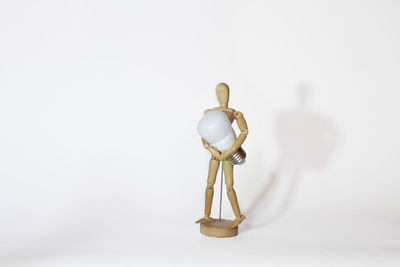 Close-up of figurine against white background