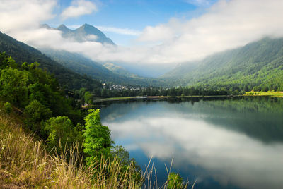 Scenic view of lake and mountains against sky