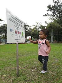 Full length of boy standing on grass