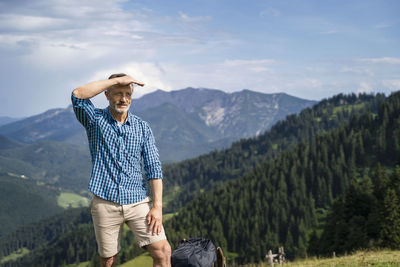 Man standing on mountain against mountains