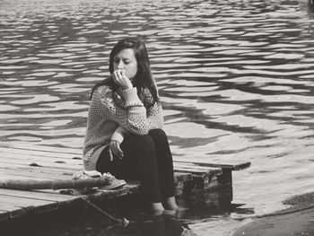 Young woman sitting in water