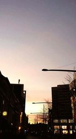 Low angle view of buildings against sky at sunset