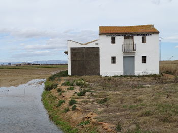 Built structure on landscape against sky