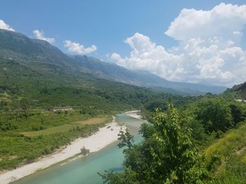 Scenic view of river amidst mountains against sky