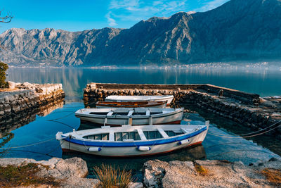 Ship moored on lake against mountains