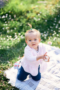 Portrait of cute girl sitting outdoors