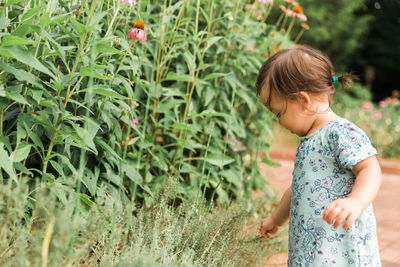 Girl standing by plants