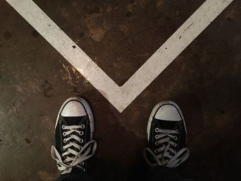 Low section of person standing on tiled floor