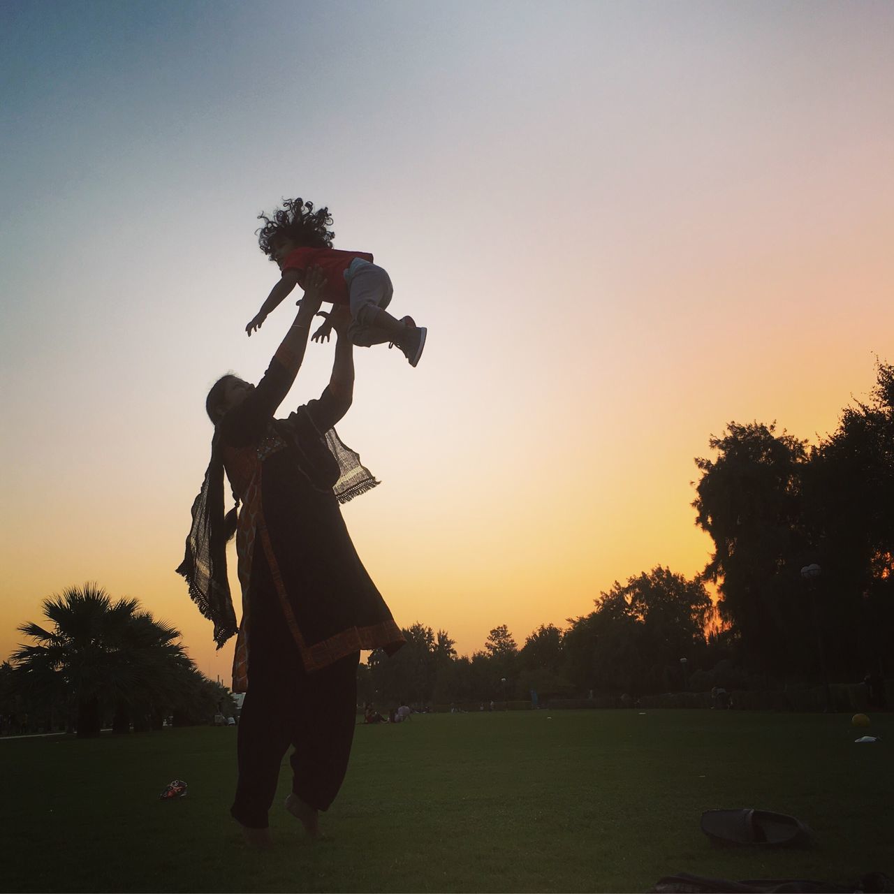 SILHOUETTE OF MAN WITH ARMS RAISED